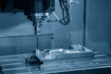 The  CMM machine measuring the injection mold parts.