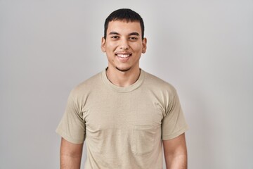 Obraz premium Young arab man wearing casual t shirt with a happy and cool smile on face. lucky person.