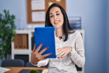 Fototapeta premium Young caucasian woman business worker smiling confident having video call at office