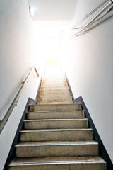 Fototapeta na wymiar Staircase going up to white light door