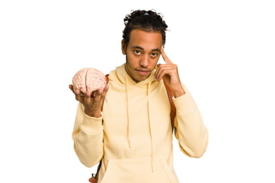 Young African American man holding a brain isolated pointing temple with finger, thinking, focused on a task.
