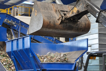 waste sorting center, excavator loading trash in a waste recycling plant is sorting waste, Environmental issues