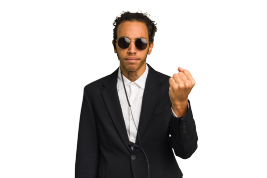 Young African American bodyguard man isolated showing fist to camera, aggressive facial expression.