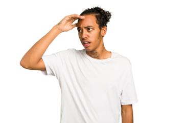 Young African American man isolated looking far away keeping hand on forehead.