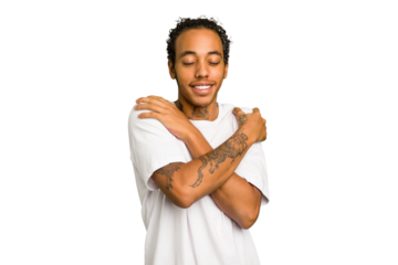 Young African American man isolated hugs, smiling carefree and happy.