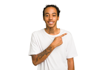 Young African American man isolated smiling and pointing aside, showing something at blank space.