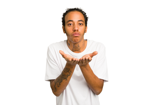 Young African American man isolated folding lips and holding palms to send air kiss.