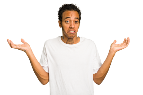 Young African American man isolated doubting and shrugging shoulders in questioning gesture.