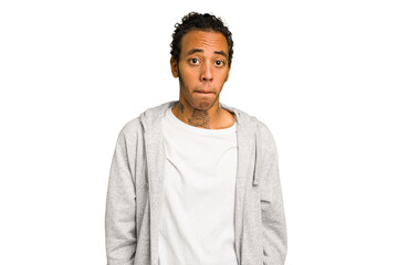 Young African American man isolated shrugs shoulders and open eyes confused.