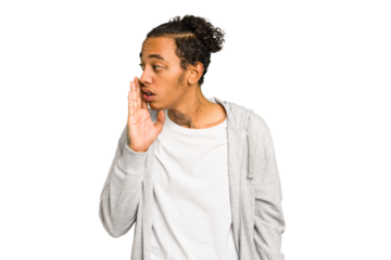 Young African American man isolated is saying a secret hot braking news and looking aside