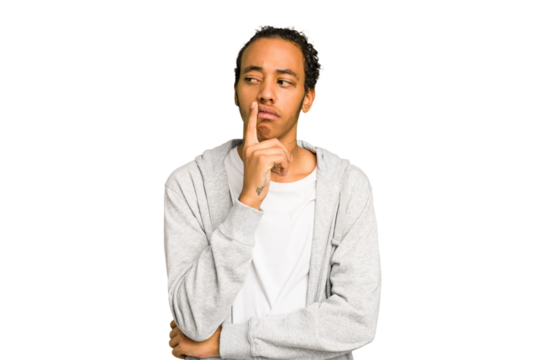 Young African American man isolated looking sideways with doubtful and skeptical expression.