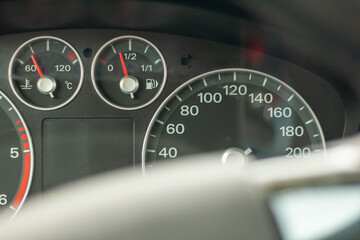 Fototapeta premium Odometer, rev counter and different vehicle or car controls, as well as climate control controls, lights, multifunction display, seat belt alert or gasoline level