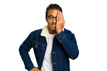 Young African American man isolated having fun covering half of face with palm.