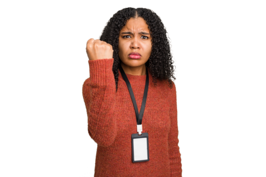 Young african american woman with ID card isolated showing fist to camera, aggressive facial expression.