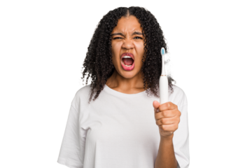 Young african american using a brushing teeth isolated screaming very angry and aggressive.