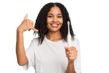 Young african american using a brushing teeth isolated showing a mobile phone call gesture with fingers.