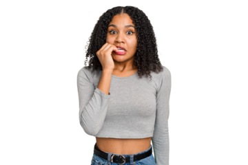 Young african american woman with curly hair cut out isolated biting fingernails, nervous and very anxious.