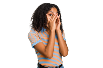 Young african american woman with curly hair cut out isolated blink through fingers frightened and nervous.