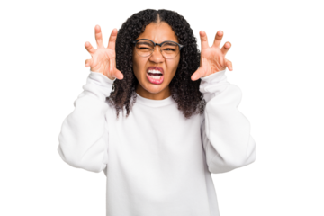 Young african american woman with curly hair cut out isolated upset screaming with tense hands.