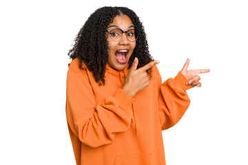 Young african american woman with curly hair cut out isolated excited pointing with forefingers...