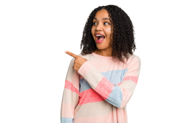 Young african american woman with curly hair cut out isolated looks aside smiling, cheerful and pleasant.