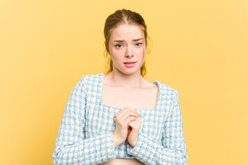 Young caucasian redhead woman isolated on yellow background scared and afraid.