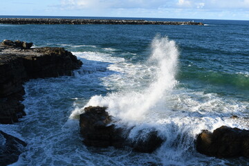 Huge waves crush on rock island and make beutiful splashes at  Yamba Lighthouse area, NSW, Australia