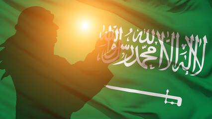Praying muslim man on Saudi Arabia flag background . Ramadan concept.