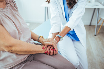 Closeup shot of an unrecognizable female doctor holding a patient's hand in comfort during a consultation inside her office Closeup shot of an unrecognizable doctor holding a patient's hand in comfort