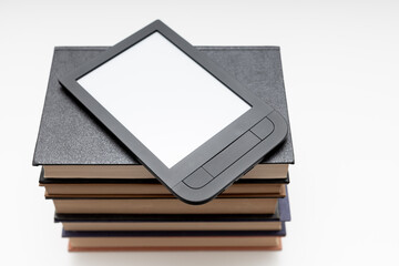 e-book lies on a stack of paper books