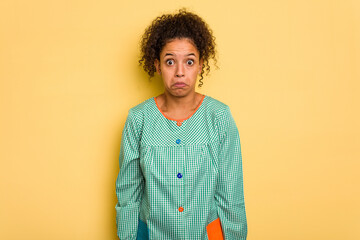 Young Brazilian child education teacher isolated shrugs shoulders and open eyes confused.