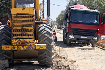 Heavy construction machines and truck outdoors for public place reconstruction.