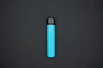 Electronic cigarette on a black background. The concept of modern smoking, vaping. Top view