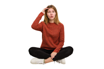 Young caucasian woman sitting on the floor cutout isolated
