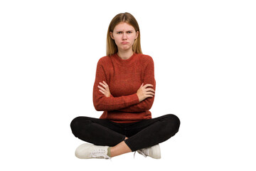 Young caucasian woman sitting on the floor cutout isolated