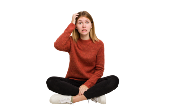 Young caucasian woman sitting on the floor cutout isolated