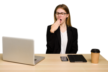 Young business caucasian woman working on her workplace cutout isolated yawning showing a tired gesture covering mouth with hand.