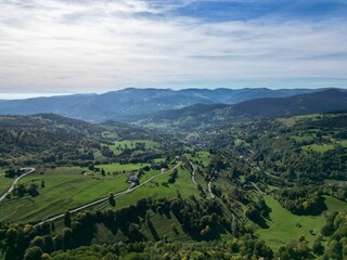 Aerial drone panoramic view on Soultzeren and Stosswihr from the Col de Wettstein and the Musmiss farm-inn in Alsace, by cloudy summer weather, Vosges green forest and mountains in background