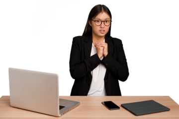 Young business asian woman sitting on a table isolated scared and afraid.