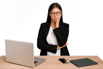 Young business asian woman sitting on a table isolated who is bored, fatigued and need a relax day.