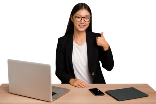 Young business asian woman sitting on a table isolated smiling and raising thumb up