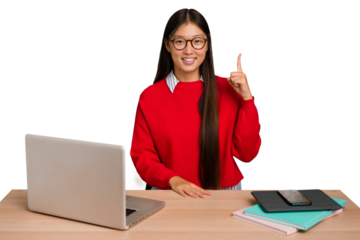 Young student asian woman in a workplace with a laptop isolated showing number one with finger.