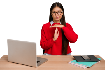 Young student asian woman in a workplace with a laptop isolated showing a timeout gesture.