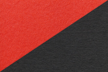 Texture of craft red and black paper background, half two colors, macro. Structure of vintage dense...