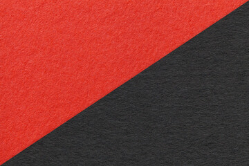 Texture of craft red and black paper background, half two colors, macro. Structure of vintage dense kraft cardboard.