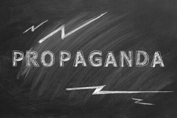 The word PROPAGANDA written in chalk on a blackboard. Information and disinformation concept. Fake news. Hand drawn illustration.