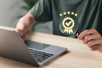 Businessman using magnifying glass at sign of the top service Quality assurance, Guarantee, Standards, ISO certification and standardization concept, satisfaction, service experience.