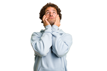 Young curly smart caucasian man cut out isolated whining and crying disconsolately.