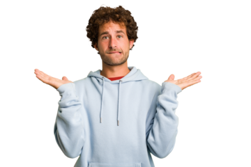 Young curly smart caucasian man cut out isolated confused and doubtful shrugging shoulders to hold a copy space.