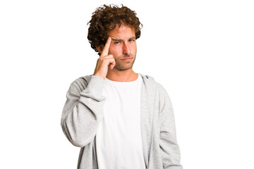 Young curly smart caucasian man cut out isolated pointing temple with finger, thinking, focused on a task.